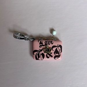 Juicy Couture luggage charm.